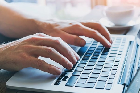 Hands typing on a keyboard
